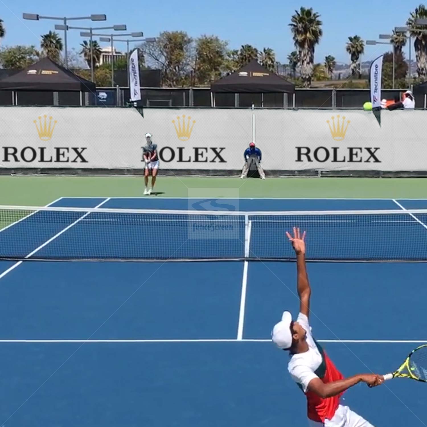 Sound-deadening fence screen beside tennis court