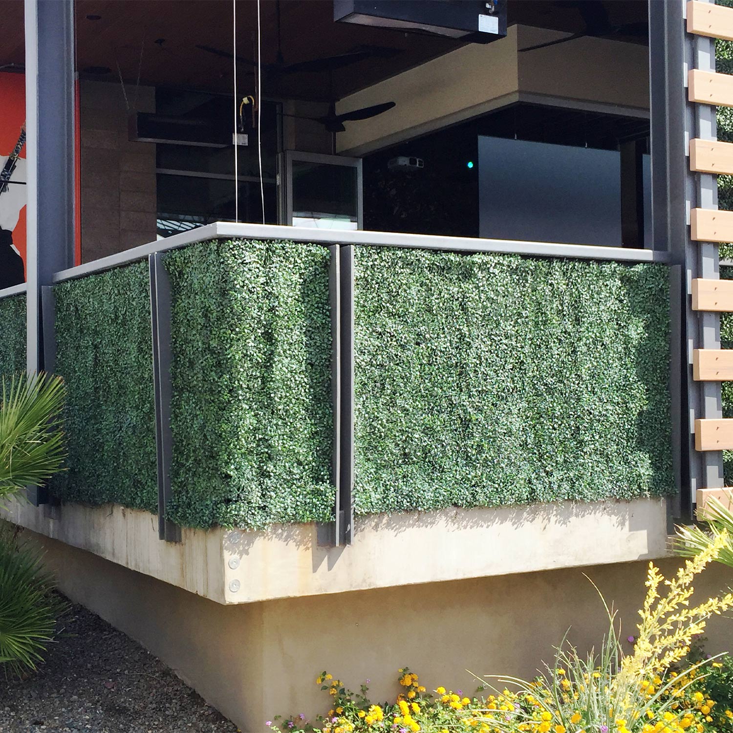 Artificial hedge screen adding greenery to a modern patio