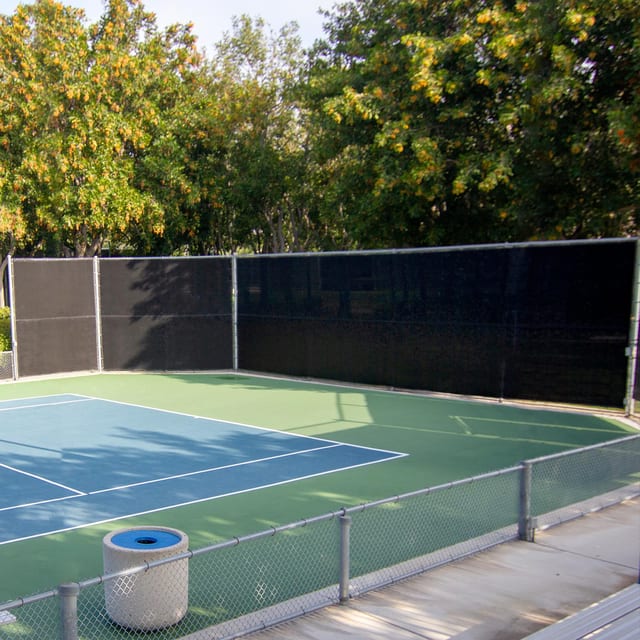 Black privacy windscreen on the fence around a tennis court