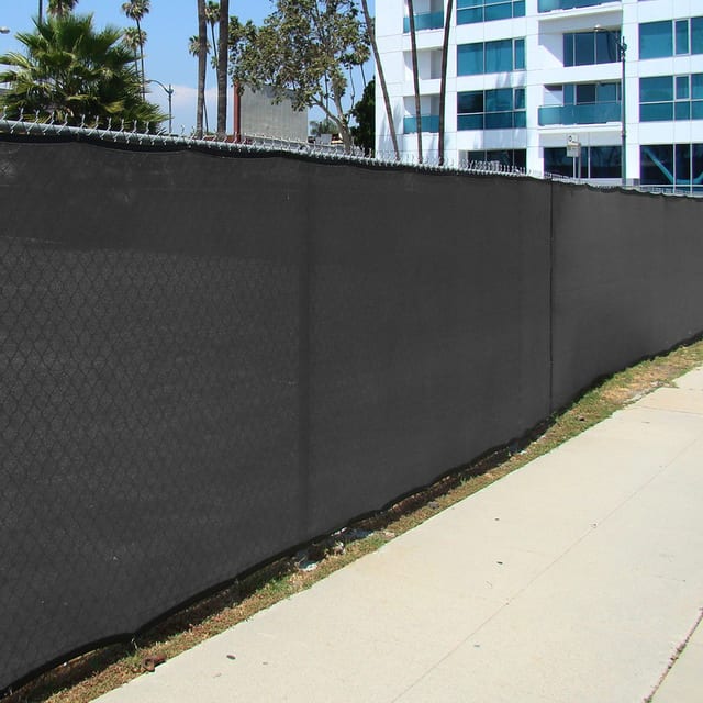 Black privacy screen along the fence of a commercial office property